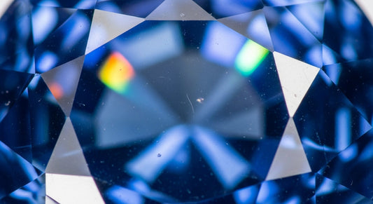 Blue sapphire showing light reflection and brilliance under white light.